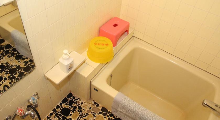 a bathroom with a toilet, sink, and tub, Yukiguni no Yado Takahan Ryokan in Yuzawa