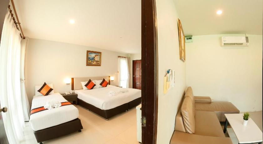 a hotel room with two beds and two lamps, Chaolao Cabana Resort (SHA Extra Plus) in Chanthaburi