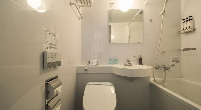 a white toilet sitting next to a white sink, SHIRAHAMA KEY TERRACE SEAMORE RESIDENCE in Shirahama