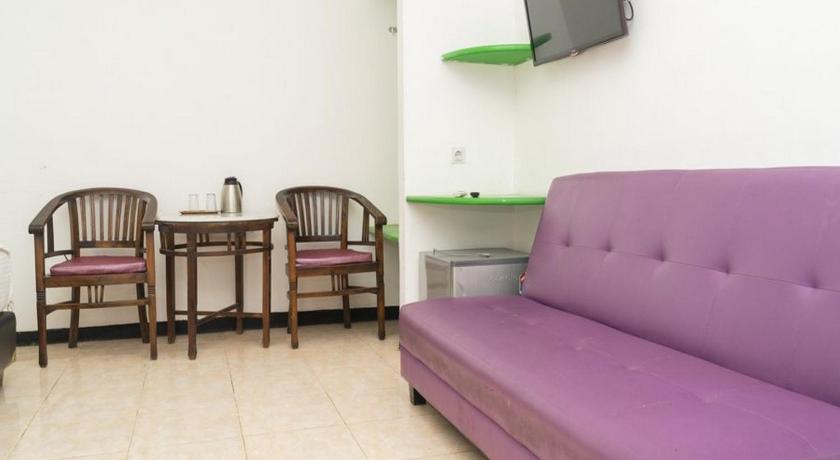 a living room filled with furniture and a tv, RedDoorz Plus @ Cibogo Puncak 3 in Puncak