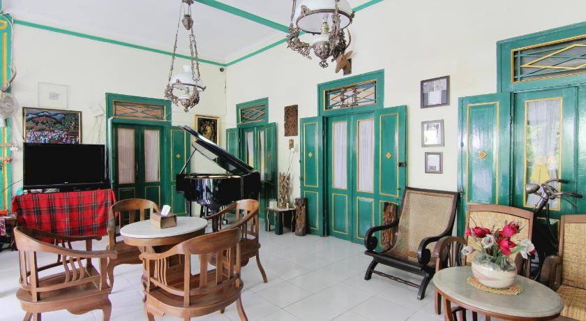 a living room filled with furniture and a piano, Pendopo Andari Homestay in Yogyakarta