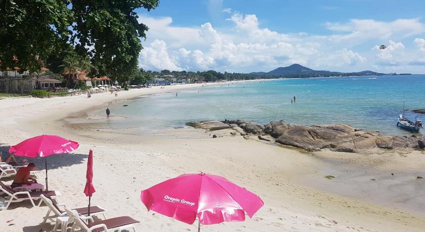 a beach with umbrellas and chairs on it, Bhundhari Chaweng Beach Resort Koh Samui (SHA Extra Plus) in Koh Samui