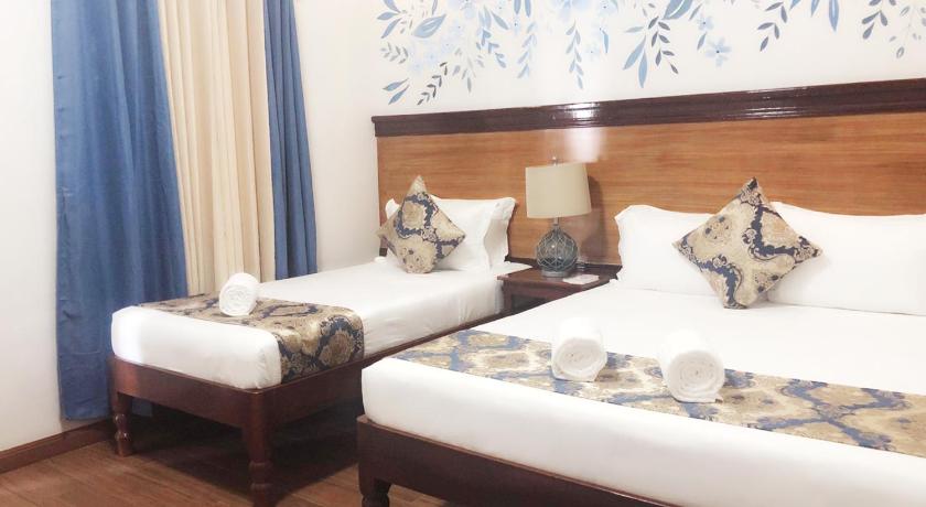 a hotel room with two beds and two lamps, Blue Waters Inn Coron Palawan in Palawan