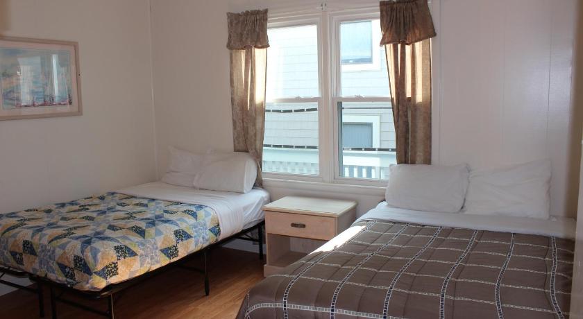 a bedroom with two beds and a window, Blue Haven Apartments in Ocean City (MD)