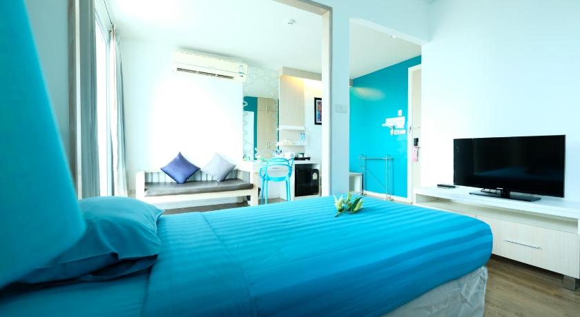 a hotel room with two beds and a television, D@Sea Hotel in Pattaya