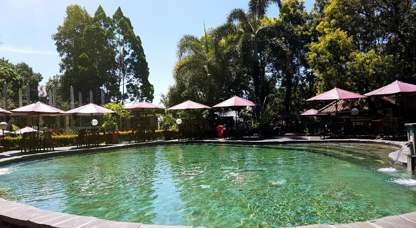 a pool with umbrellas in the middle of it, Gracia Spa Resort in Bandung
