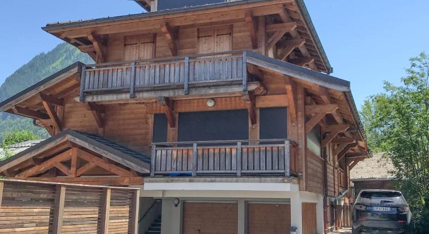 a large brick building with a large window, FARONNIERE 5 in Morzine
