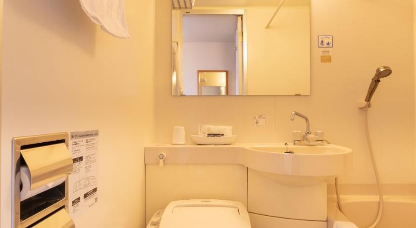 a white toilet sitting next to a white sink, Sun Hotel Tosu Saga in Saga