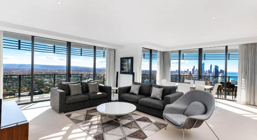 a living room filled with furniture and a large window, Peppers Broadbeach in Gold Coast