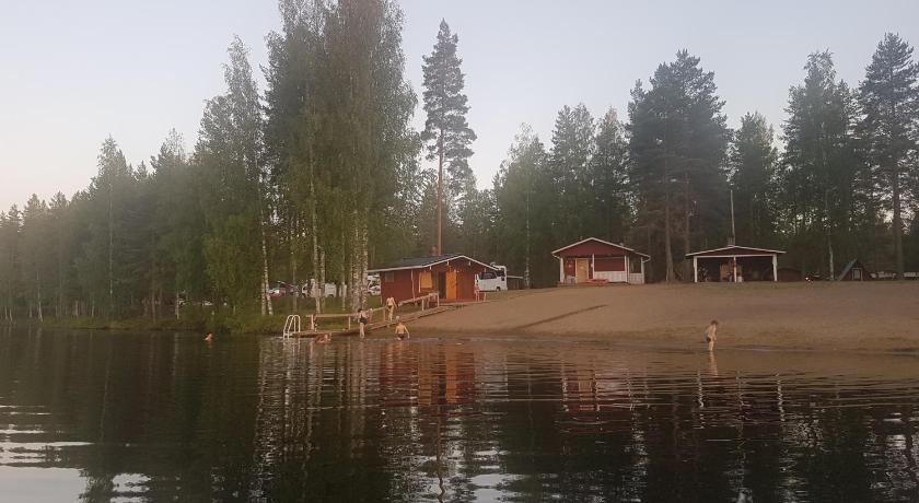a boat sitting in the middle of a lake, Camping Atrain in Kuopio