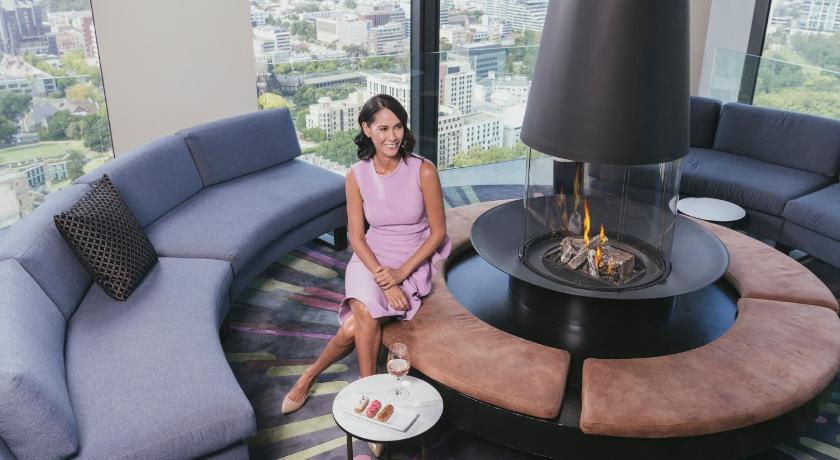 a woman sitting on a couch in a living room, Sofitel Melbourne on Collins in Melbourne