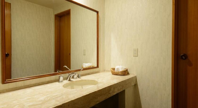 a bathroom with two sinks and a mirror, Hotel Concorde Hamamatsu in Hamamatsu
