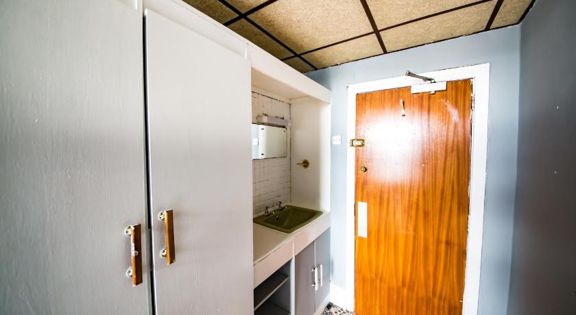 a kitchen with a sink and a door, The Silver Strand Hotel in Blackpool