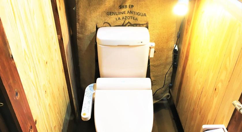 a bathroom with a toilet and a sink, 奄美ゲストハウス HUB a nice INN in Amami Ōshima