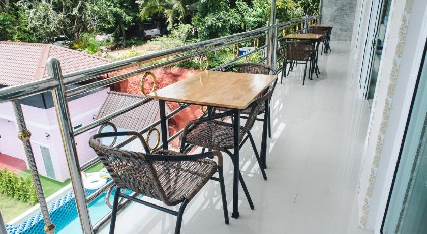 a patio area with chairs, tables, and umbrellas, Keree Lakeview in Chanthaburi