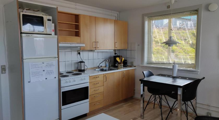 a kitchen with a stove a refrigerator and a dishwasher, Vandrehuset 2 og 3 in Nuuk