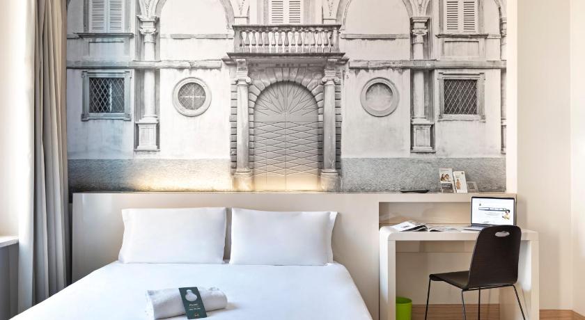 a hotel room with a bed and a desk, B&B Hotel Bergamo in Bergamo
