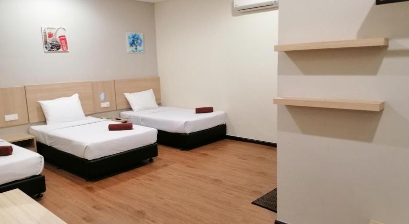 a hotel room with two beds and a couch, Northern Lodge Hotel in Sungai Petani