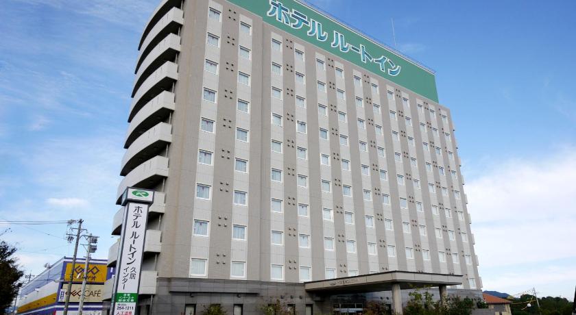 a large building with a sign on the side of it, Hotel Route Inn Hisai Inter in Tsu
