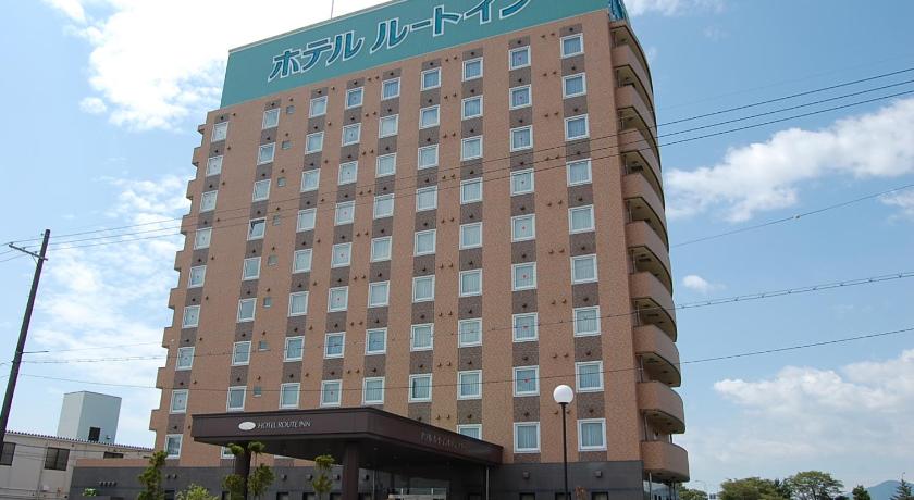 a large building with a clock on the front of it, Hotel Route Inn Nagahama Inter in Nagahama