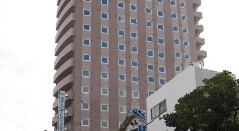 a large building with a sign on the side of it, Hotel Route Inn Tokuyama Ekimae in Shunan
