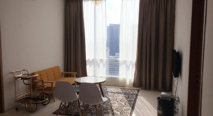 a living room filled with furniture and a window, Soho Suites KLCC by the Betty Roux in Kuala Lumpur