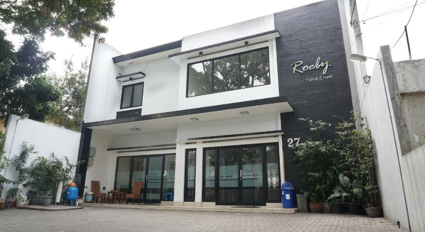 a large white building with a large window, Residences by RedDoorz Syariah @ Buah Batu in Bandung