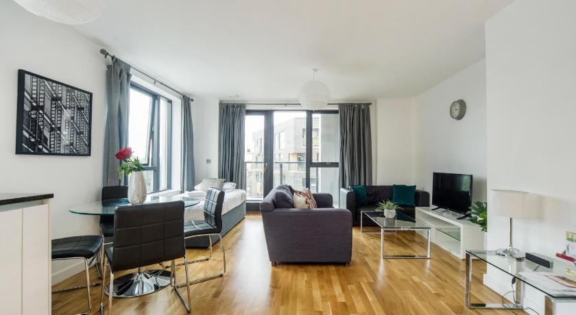 a living room filled with furniture and a window, Greenwich Two Bedroom Apartments in London