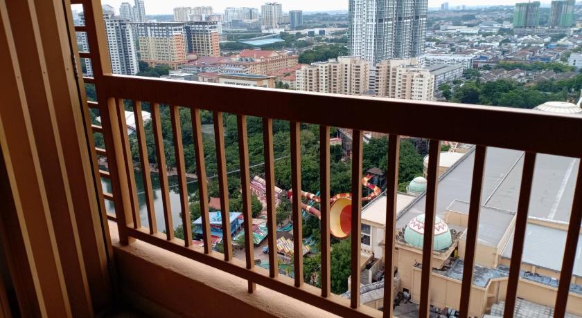 a person sitting on a balcony looking out over the water, Suite @ Sunway Pyramid Mall in Kuala Lumpur