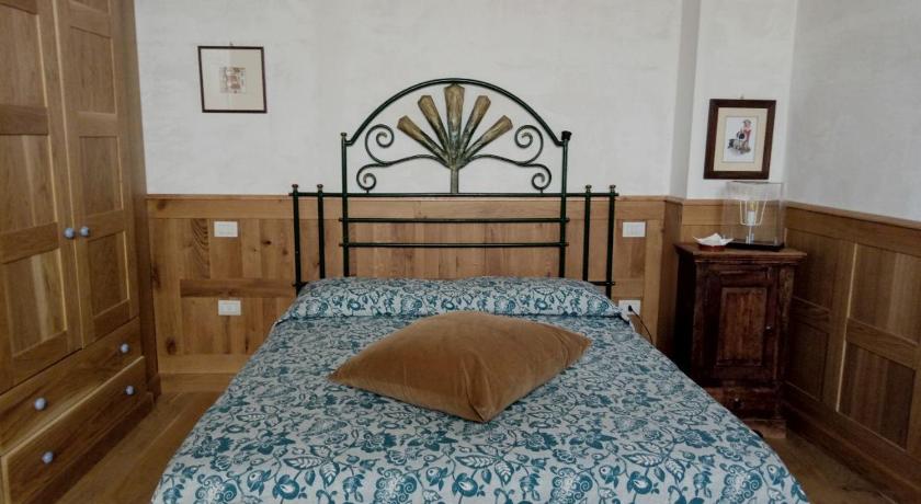 a bedroom with a bed and a dresser, Grancia dei Celestini in Sulmona