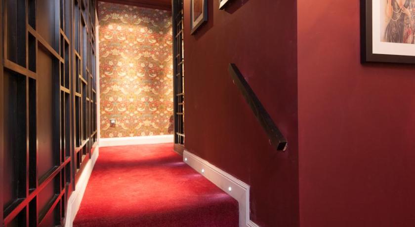 a stairway leading to a room with red walls, City Retreat Edinburgh ApartHotels in Edinburgh