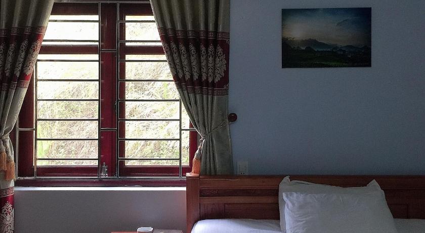 a bedroom with a bed and a window, Nhat son guesthouse in Lang Son