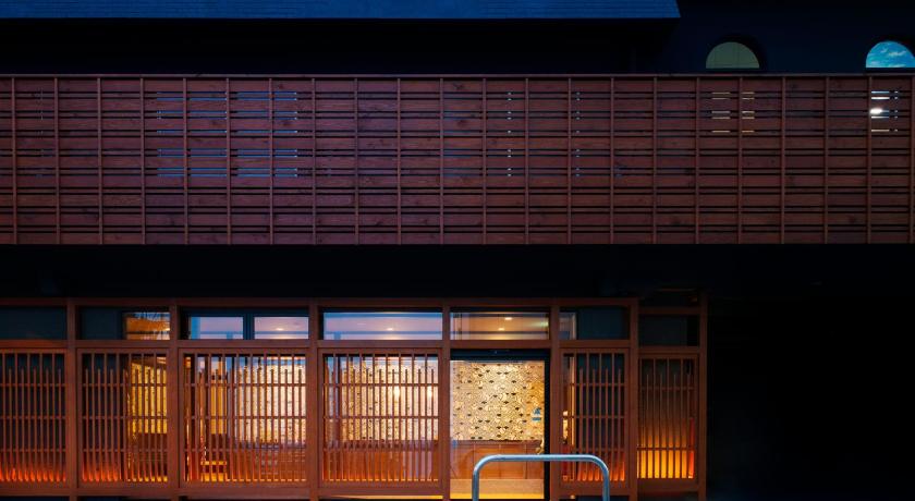 a large swimming pool with a large window, Ryokan Umiusagi in Izu