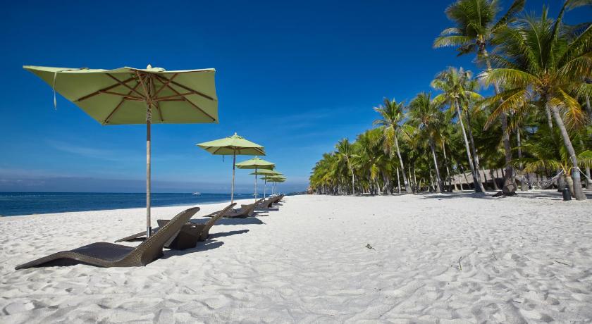 a beach with umbrellas on the sand, South Palms Resort in Bohol