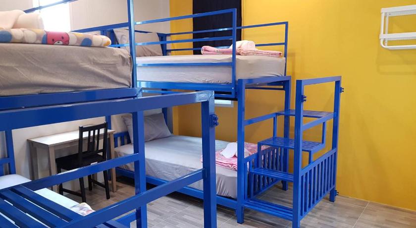 two bunk beds in a room with blue walls, The Cube Resort in Chanthaburi