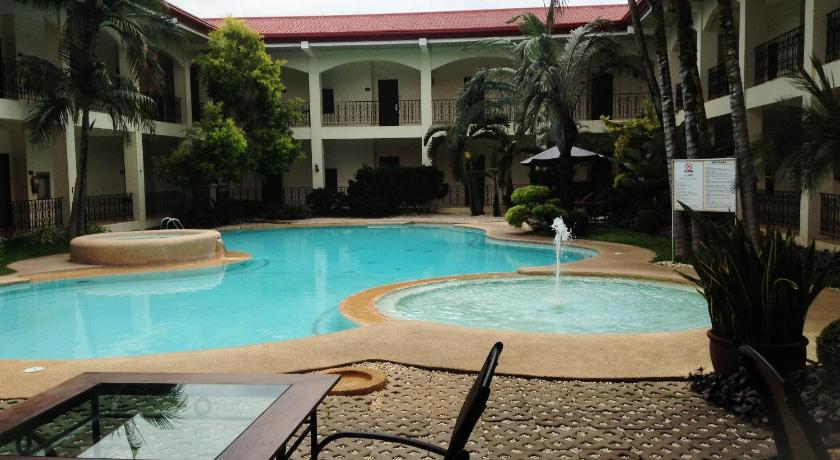 a patio with a pool, chairs, and a pool table, Citystate Asturias Hotel in Palawan