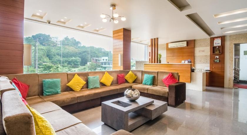 a living room filled with furniture and a large window, Hotel Five Elements in Visakhapatnam