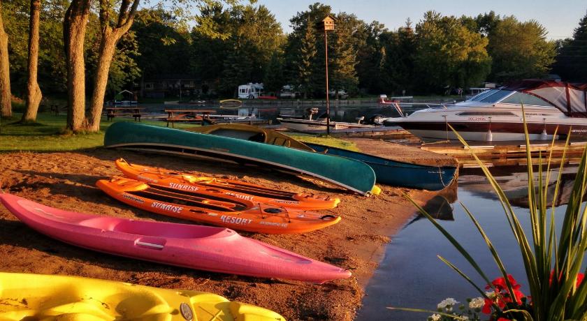 a number of small boats on a sandy beach, sunrise resort in