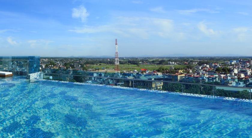 a large swimming pool with a balcony overlooking the ocean, Dragon Style Hotel in Thanh Hoá / Sầm Sơn Beach