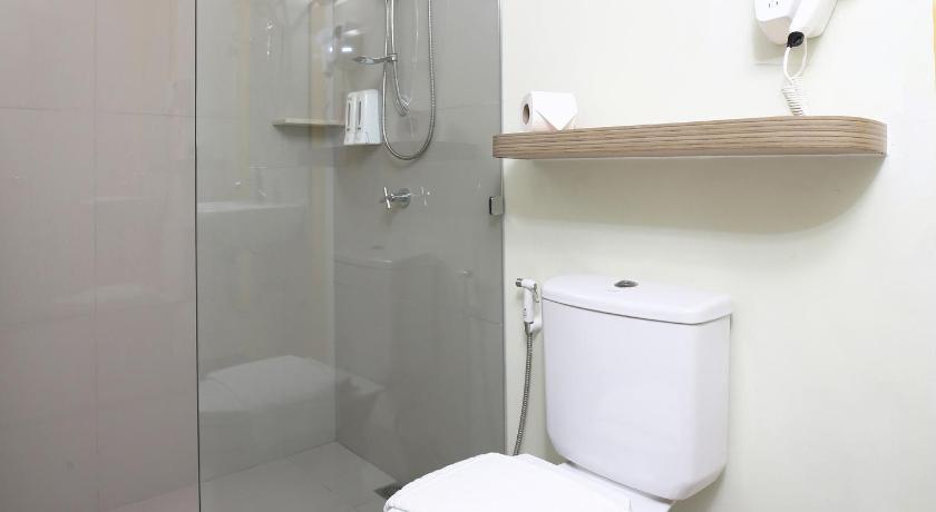 a white toilet sitting in a bathroom next to a shower, Hop Inn Hotel Aseana City Manila in Manila