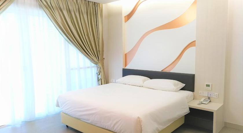 a bedroom with a large bed and a large window, Legacy Hotel in Ipoh