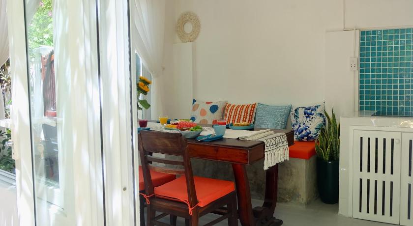 a living room with a table and chairs, An Bang Flower House in Hoi An