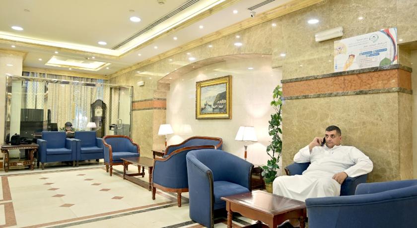 a man sitting in a chair in a hotel room, Hayah Al Waha Hotel in Medina