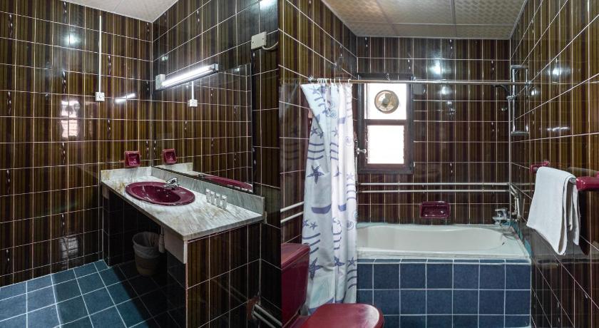 a bathroom with a sink, toilet, and bathtub, Central Paris Hotel in Dubai