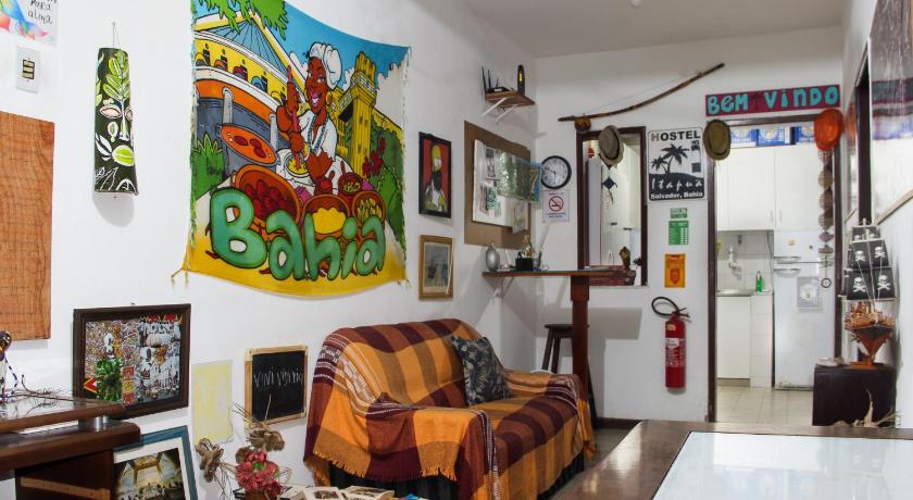 a living room with a painting on the wall, Hostel Itapua in Salvador