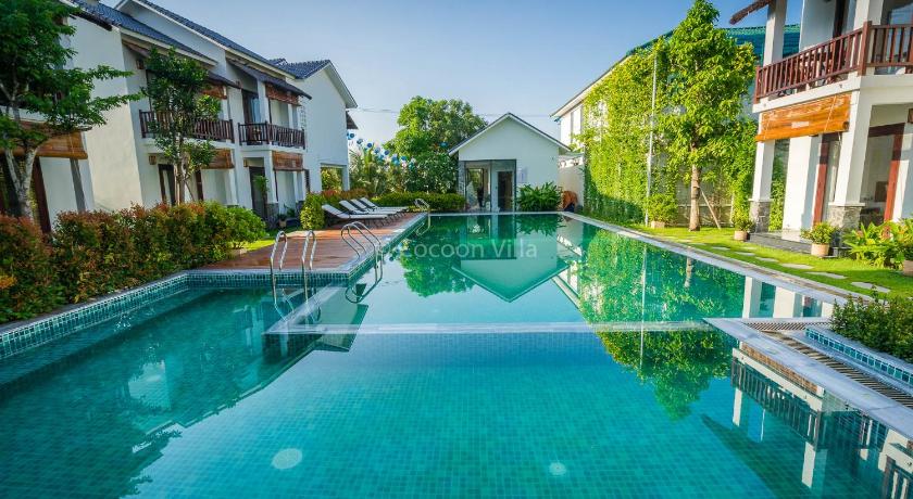 a large swimming pool in front of a house, Cocoon Villa in Hoi An