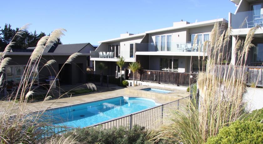 a large swimming pool in front of a house, Distinction Wanaka Serviced Apartments in Wanaka