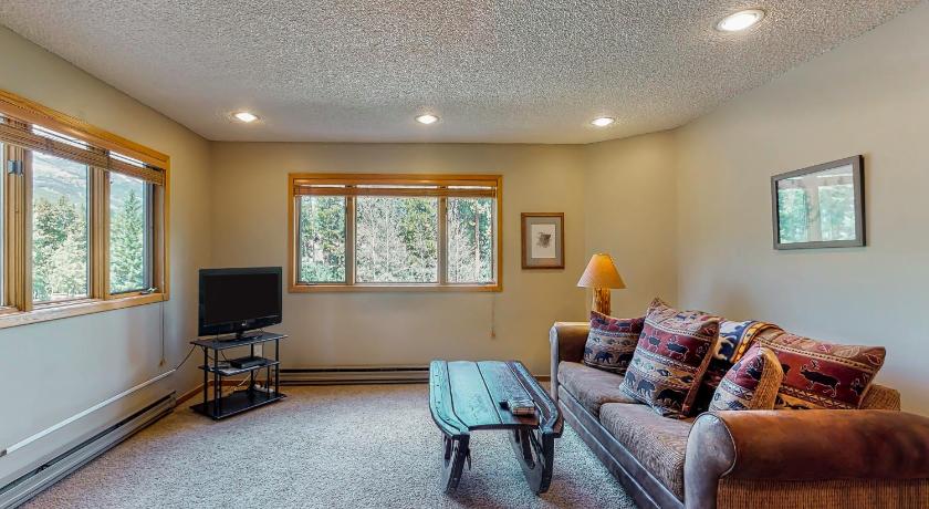 a living room filled with furniture and a tv, Woods Manor 101A in Breckenridge (CO)