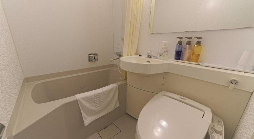 a bathroom with a toilet a sink and a bathtub, Meitetsu Inn Chitahandaeki in Chita