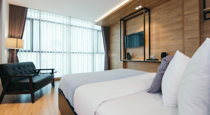 a hotel room with a large bed and a large window, Chill suites in Ho Chi Minh City